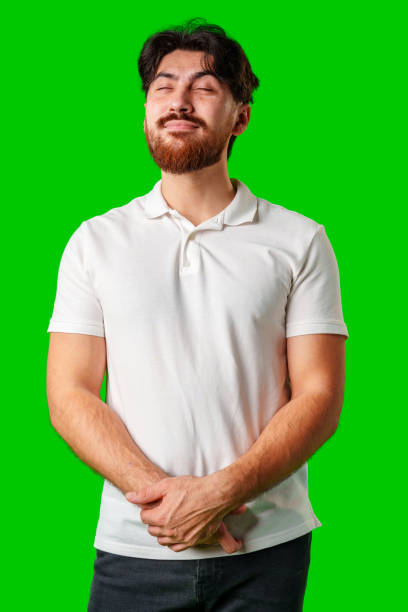 istock A man with a beard smiles confidently against a bright green background 2178662051