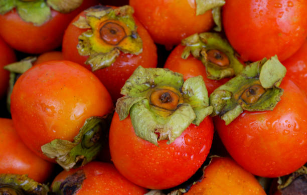 istock Wet persimmon fruits close up. 2178663446