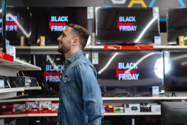 istock Man shopping for a TV during Black Friday sales event at electronics store 2178663855