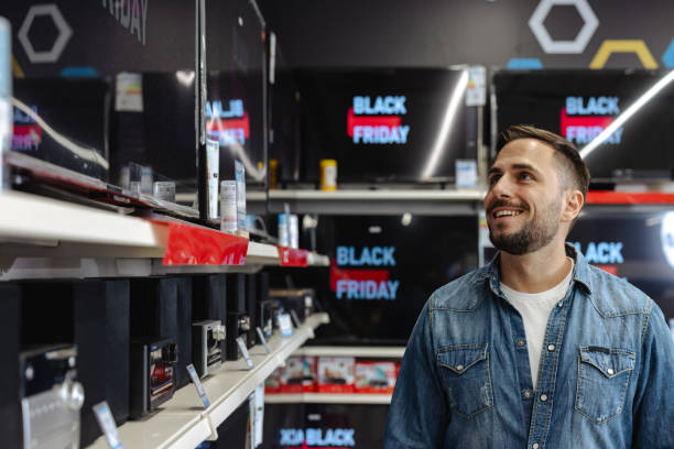 istock Happy customer exploring Black Friday deals in electronics store 2178664137