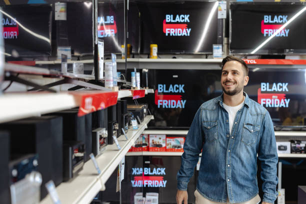 istock Happy customer exploring Black Friday deals in electronics store 2178664140