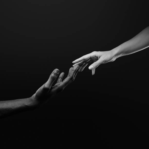 istock Two hands reaching for each other. Human relations, trust, unity, togetherness, symbolism concept 2178664978
