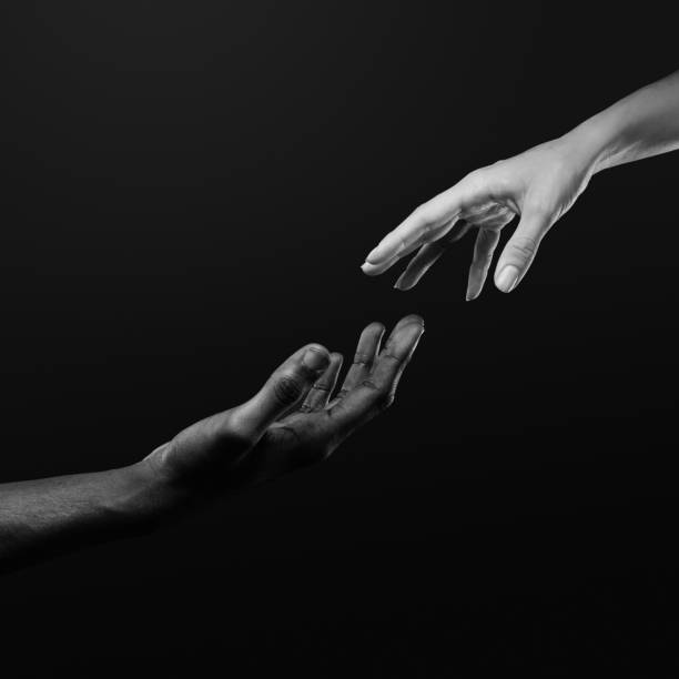 istock Two hands reaching for each other. Human relations, trust, unity, togetherness, symbolism concept 2178664979