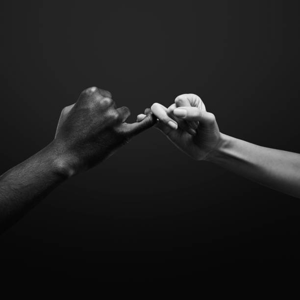istock Two hands gripping each other with pinky finger. Pinky promise. Human relations, power, unity, togetherness, symbolism concept 2178665178