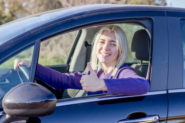 istock Woman giving thumbs up in car 2178666675