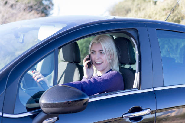 istock Blonde talking on phone in car 2178666677