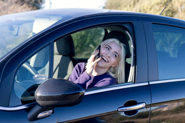 istock Blonde talking on phone in car 2178666680