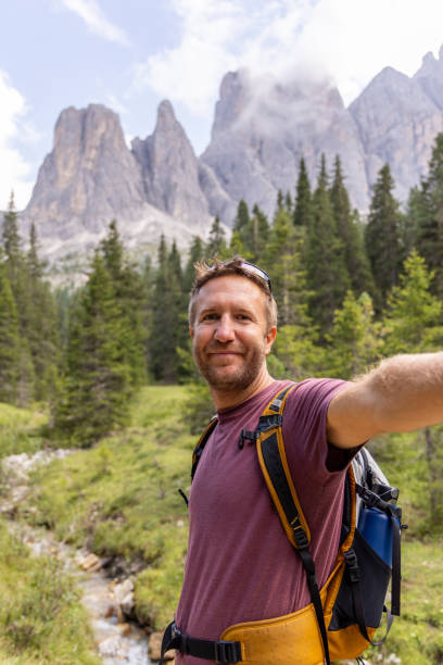 istock Joyful man hiking in the Dolomites and taking a selfie 2178670099