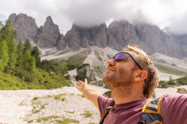 istock Man Embracing Nature with Open Arms in Mountain Landscape 2178671392