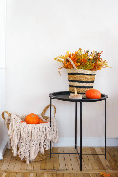 istock Rustic autumn decorations featuring pumpkins and woven basket in cozy home interior setting 2178673417