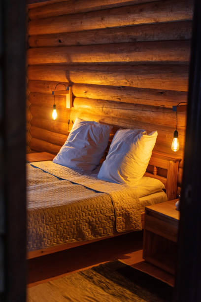 istock Cozy Log Cabin Bedroom with Warm Lighting 2178674569