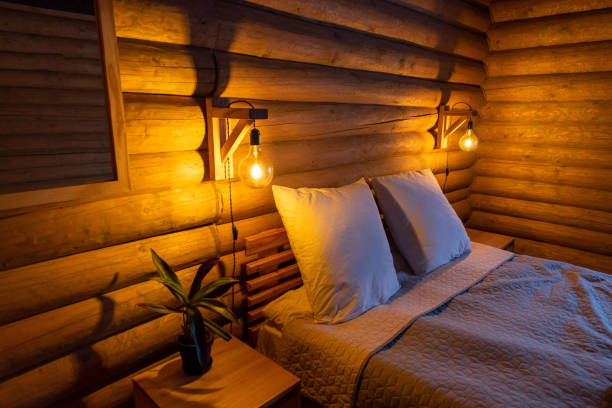 istock Cozy Log Cabin Bedroom with Warm Lighting 2178674613