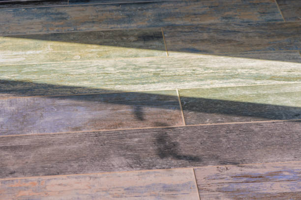 istock Sunlight Casting Soft Shadows on Textured Wooden Floor Tiles, Adding Warmth and Character to a Cozy Interior 2178676179