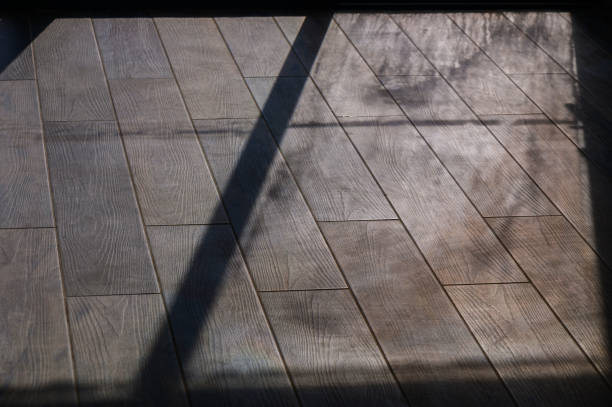 istock Winter Sunlight Streams Through a Window Casting Intricate Shadows on Polished Wooden Flooring in a Cozy Indoor Space 2178676183