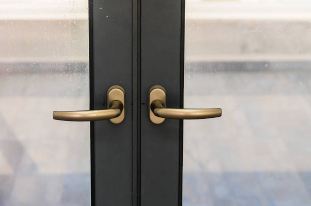 istock Modern Bronze Handles Adorn Sleek Glass Doors in an Urban Setting Inviting Exploration and Warmth 2178676186