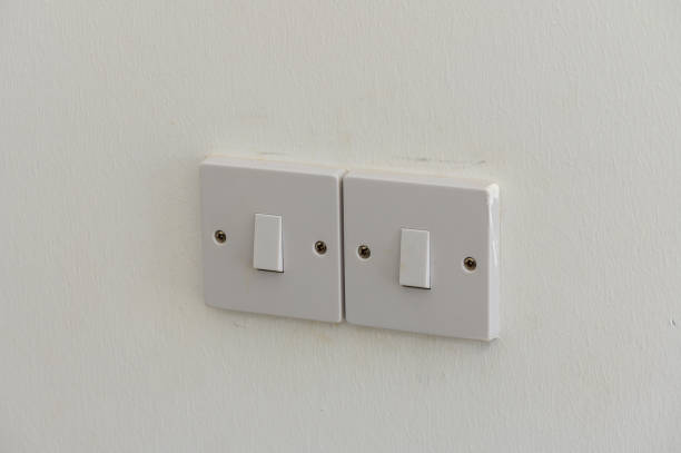 istock Two White Light Switches Mounted on a Pristine Wall, Ready to Illuminate a Cozy Room at Any Moment 2178676217