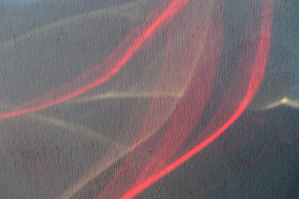 Abstract Light Trails Create a Dynamic Interplay of Colors Against a Textured Surface in an Artistic Display at Twilight