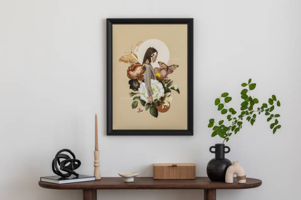 istock Stylish and minimalist composition on wooden design commode with mock up poster frame, flowers in vase, decorations and personal accessories. Template. 2178678106