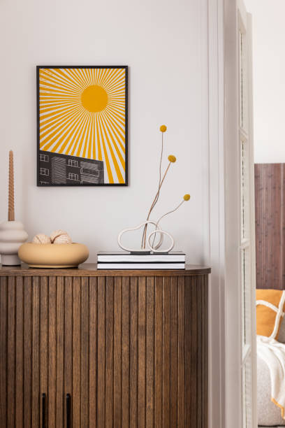 istock Modern hallway decor with mock up  bright yellow sunburst art piece, simple sculptures, and wooden furniture, adding warmth and style. Home decor. 2178680486