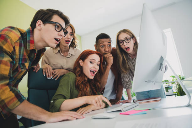Photo of group five young corporate workers new project excitement press start button workstation office business center indoors.