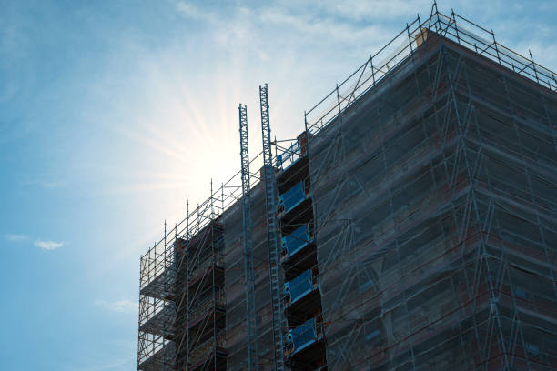 istock Scaffold sheeting net wrapped apartments building during insulation in england uk 2178683736