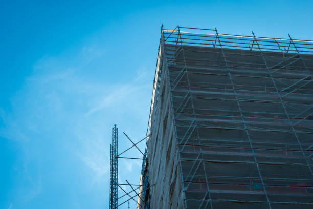 istock Scaffold sheeting net wrapped apartments building during insulation in england uk 2178683740