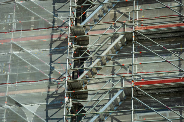 istock Scaffold sheeting net wrapped apartments building during insulation in england uk 2178683760