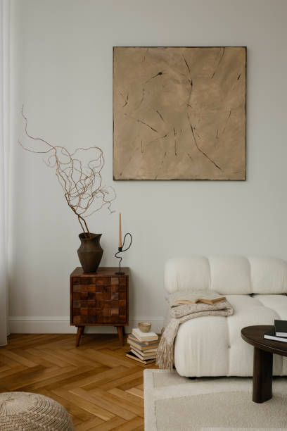istock A stylish, minimalist living room area featuring a mid-century modern commode with a cozy decorations, leafs in vase. The room includes elegant decor, soft lighting, and a tranquil ambiance. 2178684643