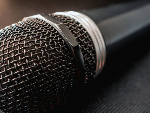 istock Close up of microphone on black background 2178684806