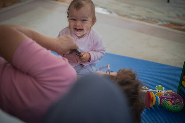 Curious baby uses grandma's smartphone, plays