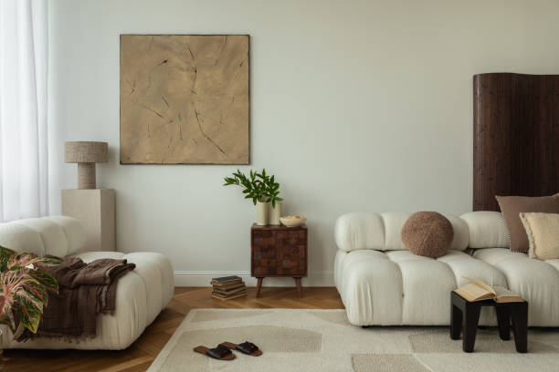 istock A stylish living room interior with white sofas, a wooden side table, abstract wall art, and minimalist decor. The space includes a soft rug, indoor plants, and cozy accents, creating a serene and modern ambiance. 2178686558