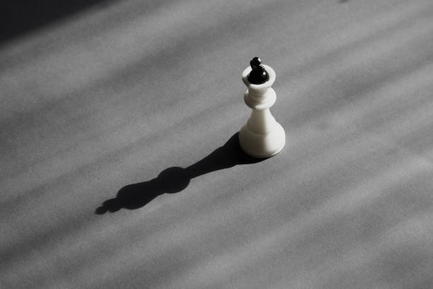 istock White chess king in soft sunlight and black shadow on a gray background, solitary candidate, career sunset, political solitude, fragility of power and necessity of protection 2178687190