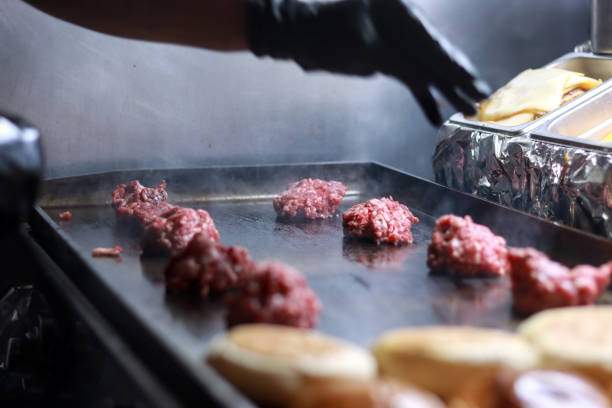 istock Unrecognizable person cooking raw smash burger balls on a grill 2178688987