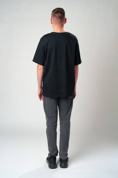 istock Back view of a casual man standing on gray backgorund in studio 2178689258