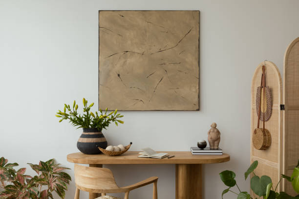 istock Aesthetic interior design featuring a wooden console, furniture  adorned with decorative vases, candles and  sculptures. A large abstract painting adds a modern touch. Stylish space. Template. 2178689946