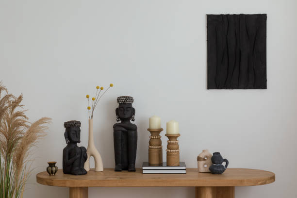istock Aesthetic interior design featuring a wooden console, decorative vases, candles, and black sculptures. Black mock up paintings and natural elements into the cozy, stylish space. Template. 2178689965