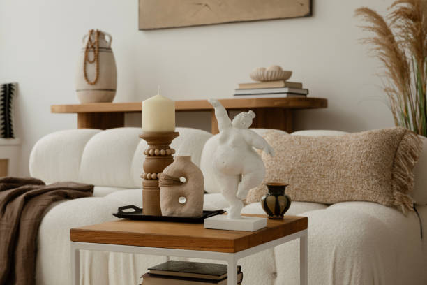 A subtle and serene interior with a unique sculpture, textured fabrics, and warm lighting. The neutral color palette enhances the tranquil and sophisticated vibe of the space.
