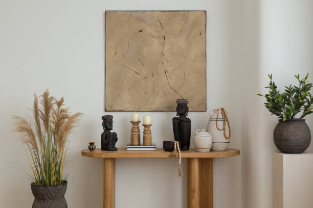 istock Ethnic-inspired decor with wooden table.  A beautifully styled wooden table adorned with ceramic vases and Buddha sculptures, enhancing the room's bohemian vibe. 2178690066