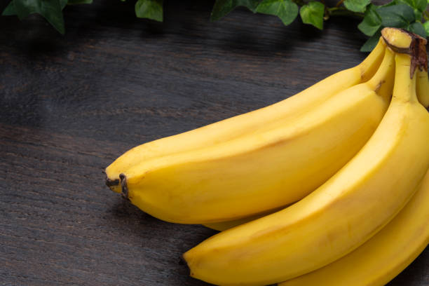 istock Fresh bananas on wooden table 2178690299