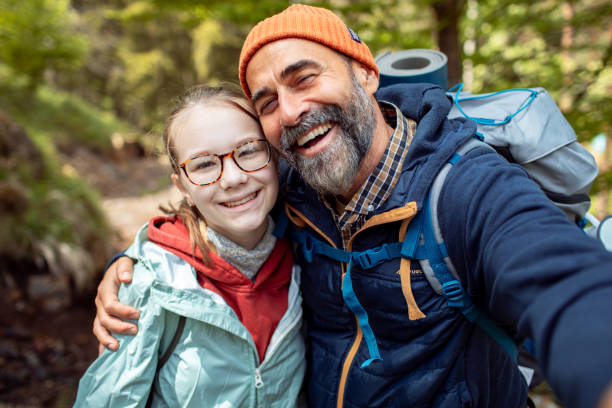 istock Father and daughter taking a selfie while out hiking and camping in a forest 2178691148