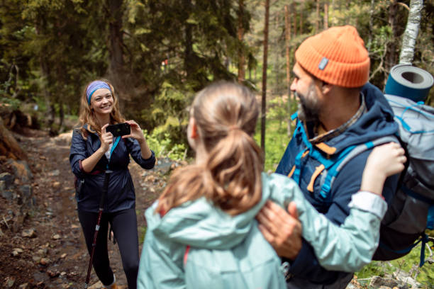 istock Young family taking a picture while out hiking in a forest 2178691176