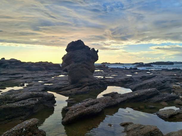 istock A striking coastal landscape at sunset with rocky formations. A rocky shore with numerous tidal pools reflecting the sky. 2178691729