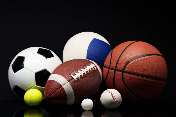 Various sports equipment on black background studio shot close up