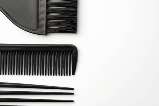 Black plastic hair comb isolated on white background close up