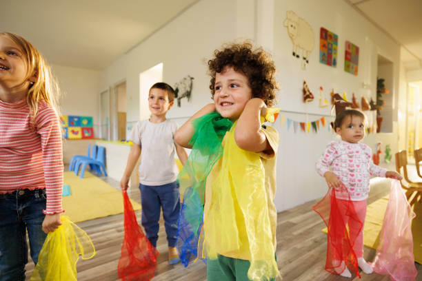 istock Kids having fun dancing whit colorful scarves 2178694555