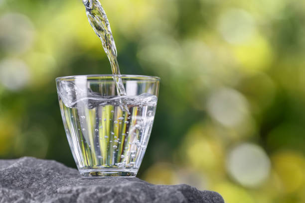 istock drinking water pouring into glass on stone 2178695781