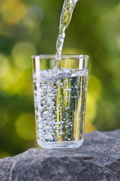istock drinking water pouring into glass on stone 2178695801