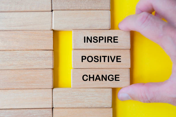 istock Hand pulling out wooden blocks with Inspire Positive Change text 2178698349