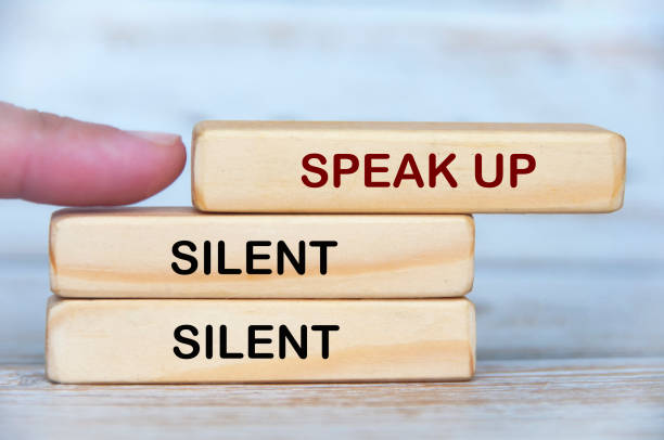 istock Hand pushing wooden block with speak up text. Speak up and courage concept 2178698351
