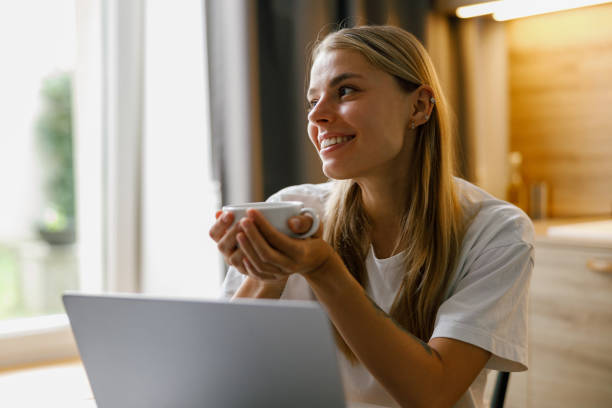 istock A young woman is thoroughly enjoying her coffee while she smartly works on her laptop today 2178698544